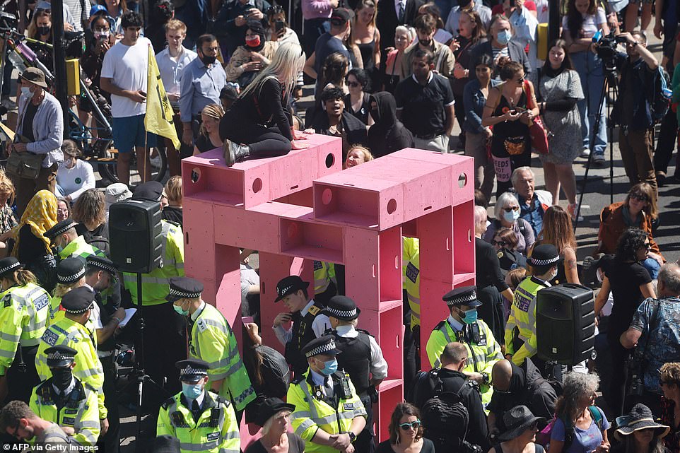 47085827-9925553-The_bright_pink_construction_had_a_protester_on_top_of_it_as_pol-a-26_1629910478350.jpg