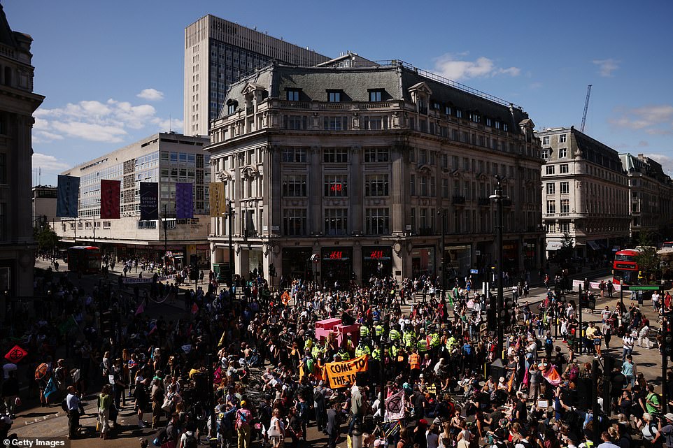 47085833-9925553-Extinction_Rebellion_protesters_gather_at_Oxford_Circus_to_prote-a-33_1629910478358.jpg