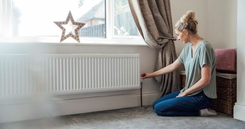 woman-looking-at-her-radiator.jpg