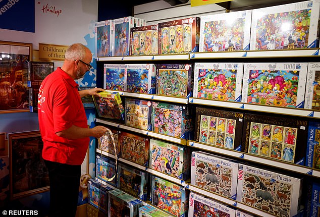 49161295-10093659-A_staff_member_prices_jigsaws_at_Hamleys_in_London_s_West_End_as-a-92_1634249625913.jpg